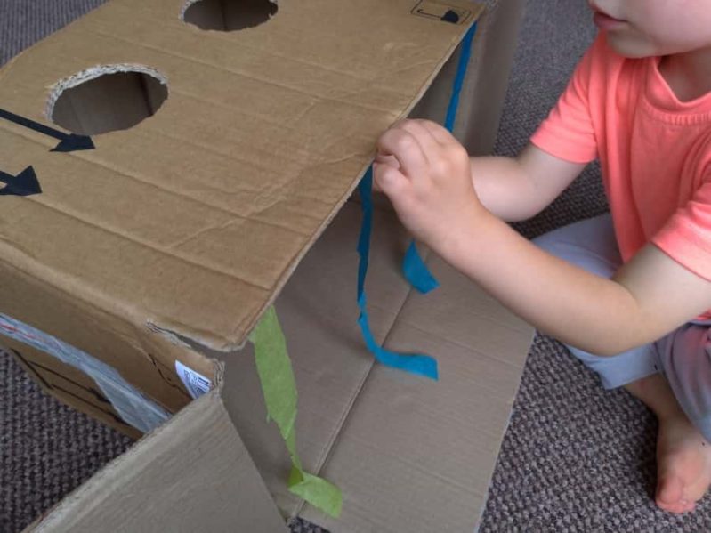 Decorate your DIY sensory guess what's in the box game with the tissue paper or ribbons or party streamers.